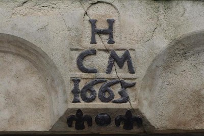 A 17th century triad incorporated into a commemorative plague carved into a stone door lintel in a building in Market Street, Lower Holker, Cumbria, England.