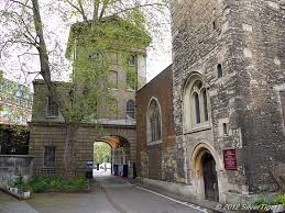 The rear of St. Bartholomew Hospital's King Henry VIII Gate showing the west end entrance to the parish church of St. Bartholemew the Less